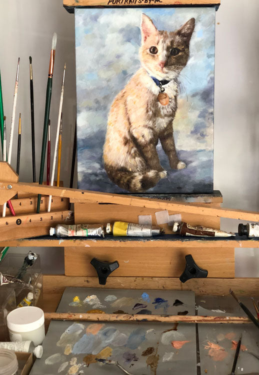 cat painting on easel