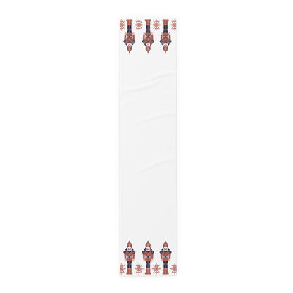 White table runner with decorative nutcracker pattern on a white background