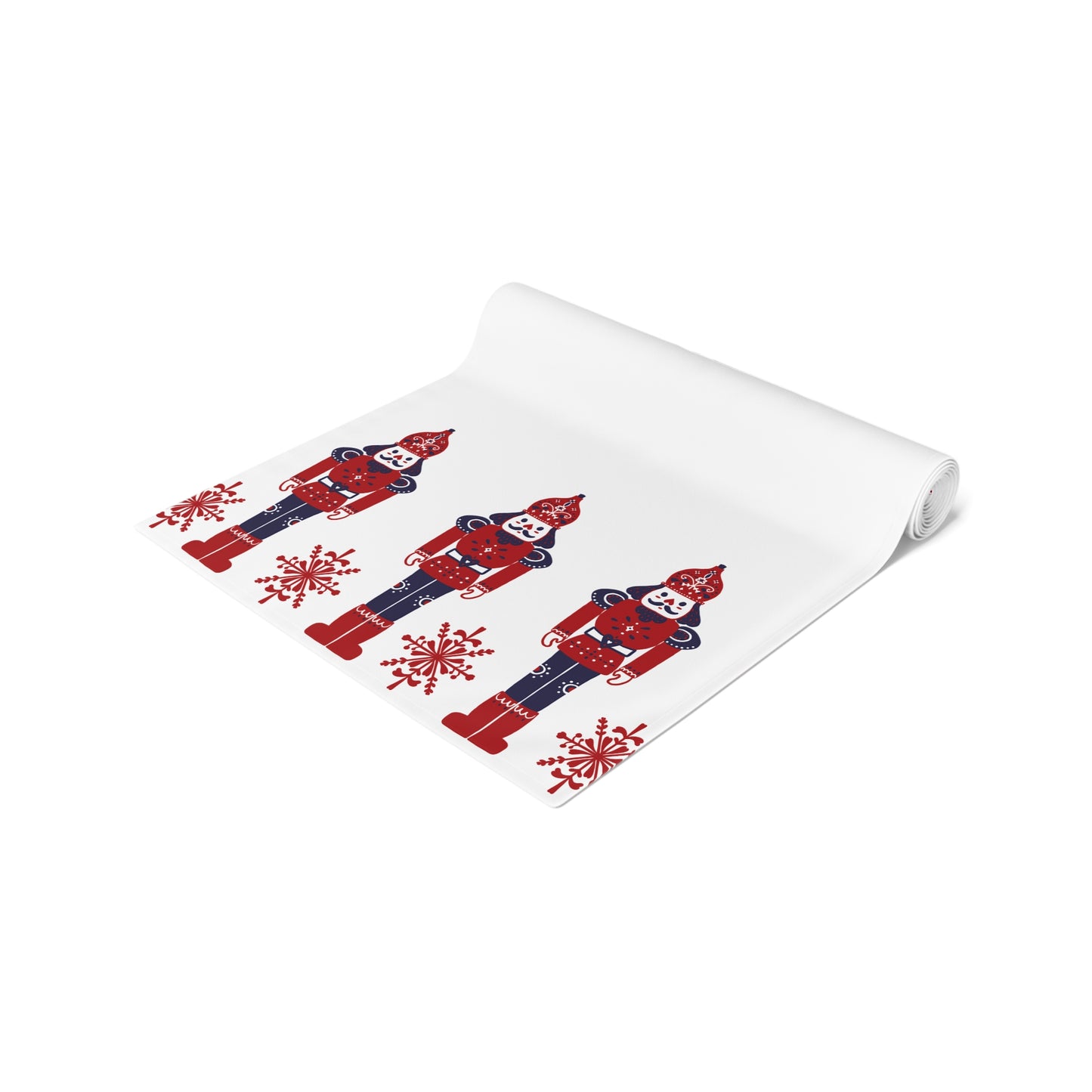 Folded white runner with red and blue nutcracker design on a white background