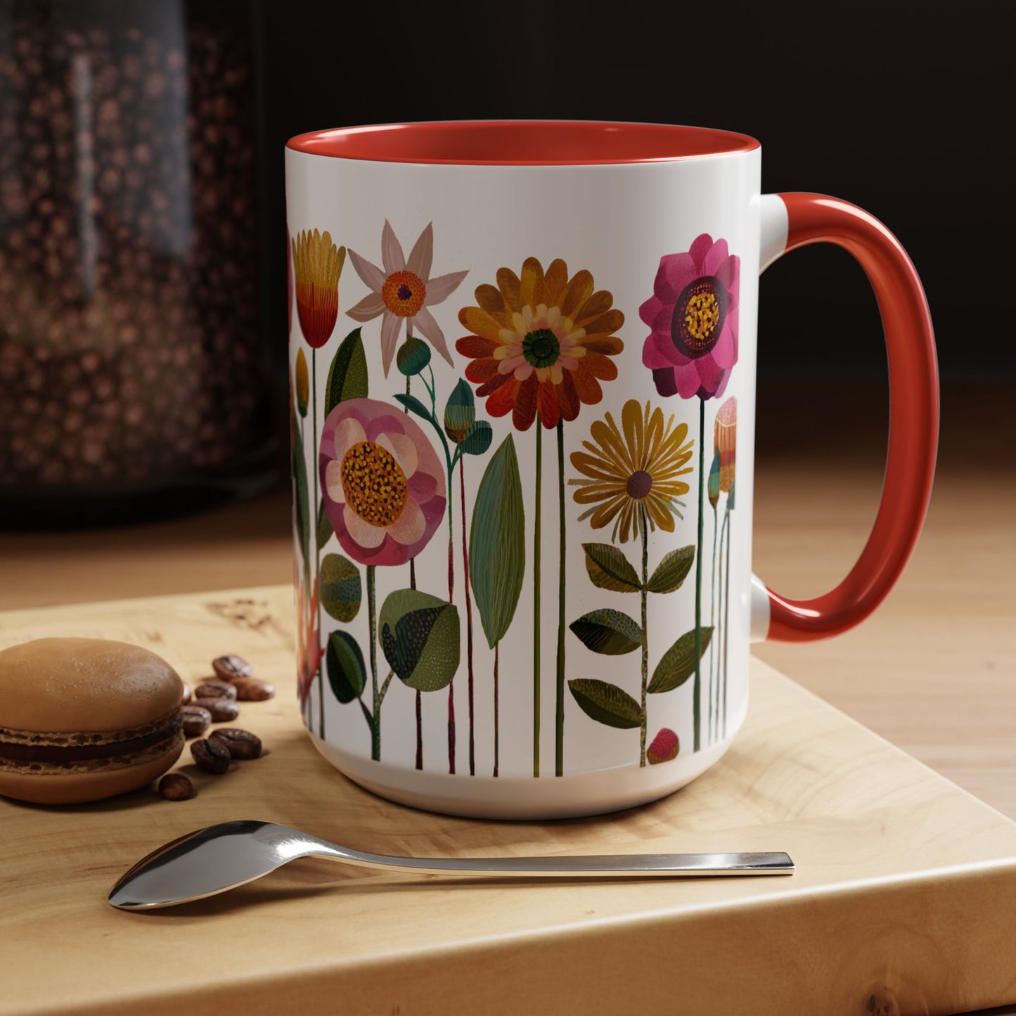 15 oz Floral-patterned mug with red interior and handle on a wooden surface with coffee beans and a macaron.