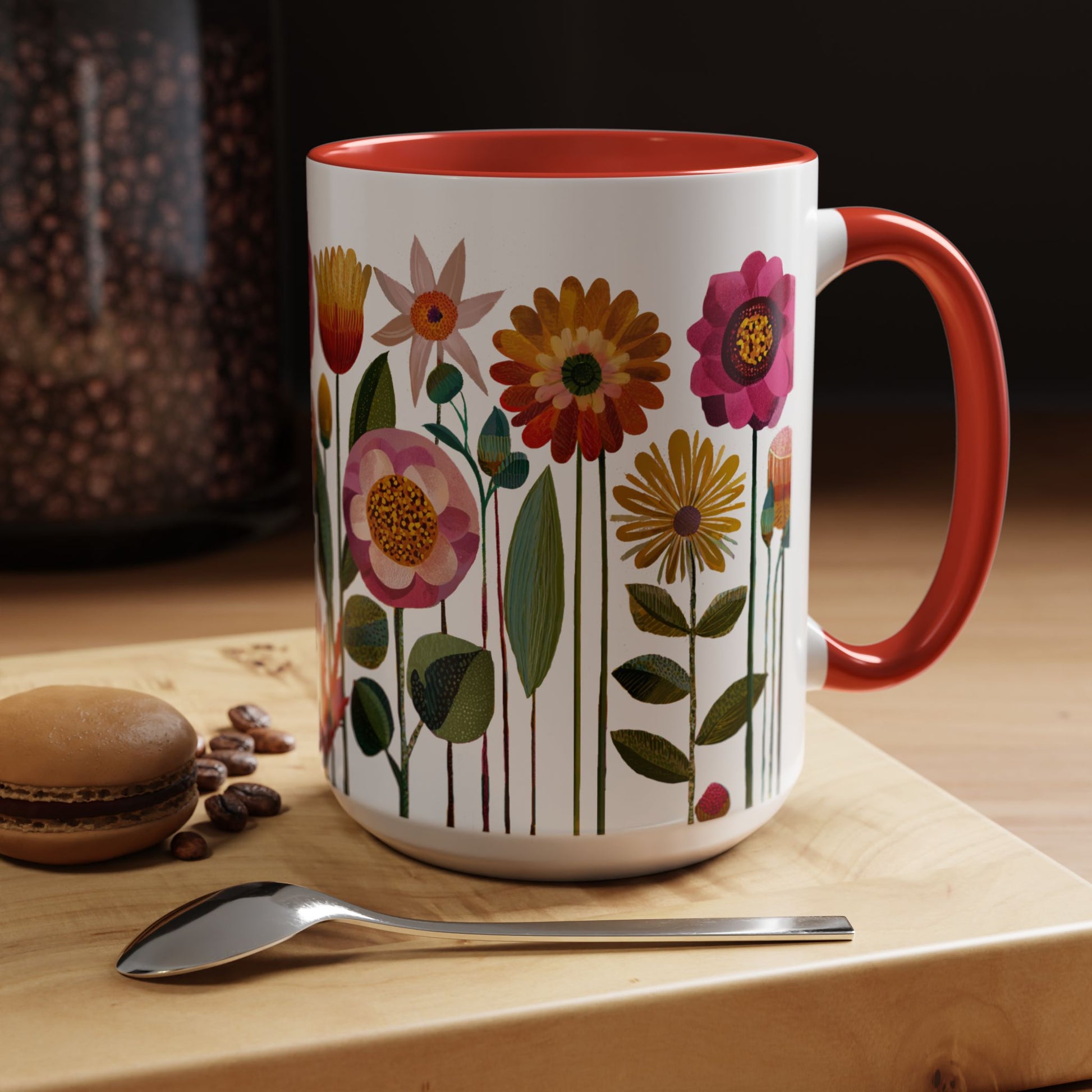 15 oz Floral-patterned mug with red interior and handle on a wooden surface with coffee beans and a macaron.