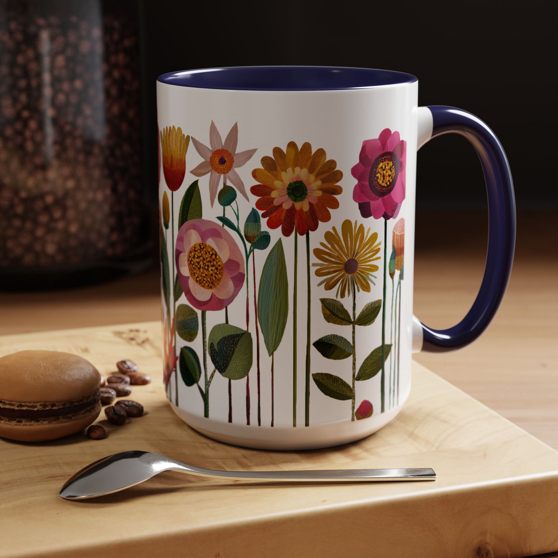 15 oz Navy Blue Mug with floral design on a wooden surface with coffee beans and a spoon.