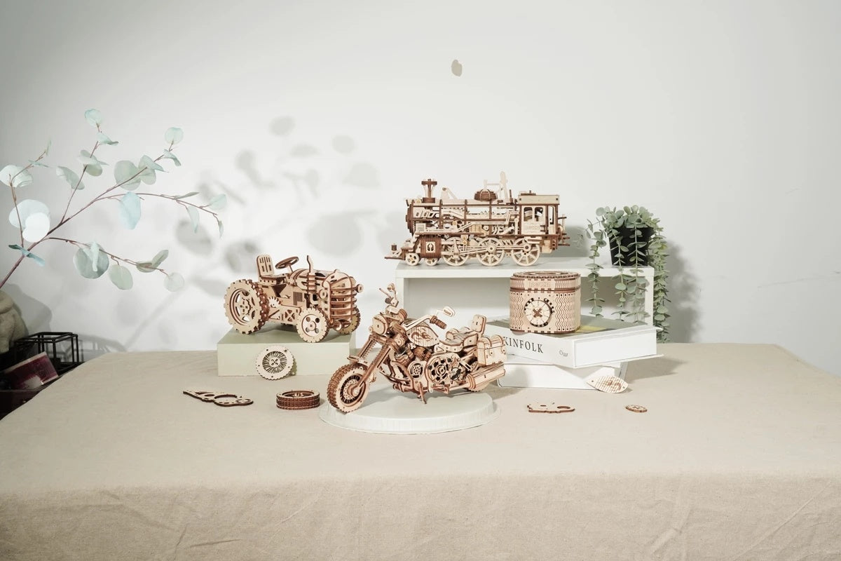 Wooden model trains and cars on a table with a decorative background Robotime Rokr Cruiser Motorcycle DIY Wooden Model 420 Pcs Building Wooden Kit
