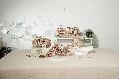 Wooden model trains and cars on a table with a decorative background Robotime Rokr Cruiser Motorcycle DIY Wooden Model 420 Pcs Building Wooden Kit