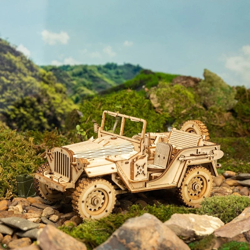 Wooden model of a jeep on a rocky landscape with green hills in the background 3D Wooden Puzzle Model Toys Car Kit MC701