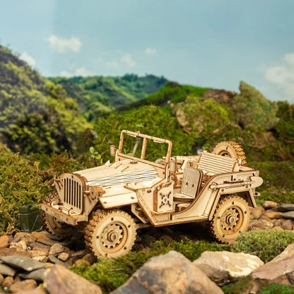 Wooden model of a jeep on a rocky landscape with green hills in the background 3D Wooden Puzzle Model Toys Car Kit MC701