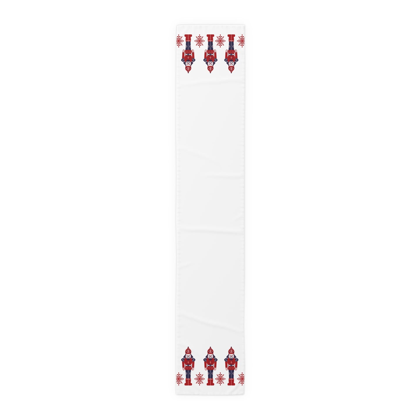 White table runner with red and blue Scandinavian nutcracker designs on a white background