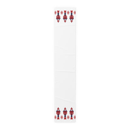 White table runner with red and blue Scandinavian nutcracker designs on a white background