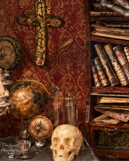 A miniature diorama setup featuring a vintage skull, glass bottles, a globe, a compass, and a bookshelf filled with scrolls against a red damask wallpaper background.